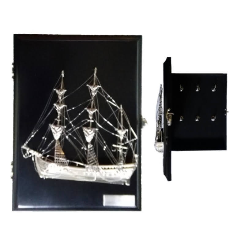 Keyhanger with silvery brass sailboat in locker
